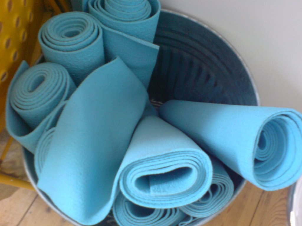 Yoga mats in a bin